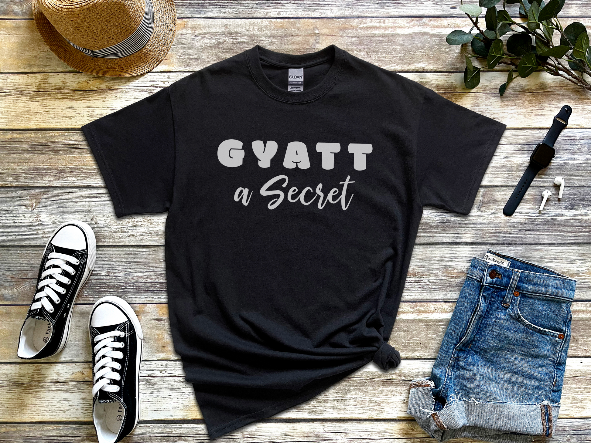 a t - shirt that says gyatt a secret next to a pair of