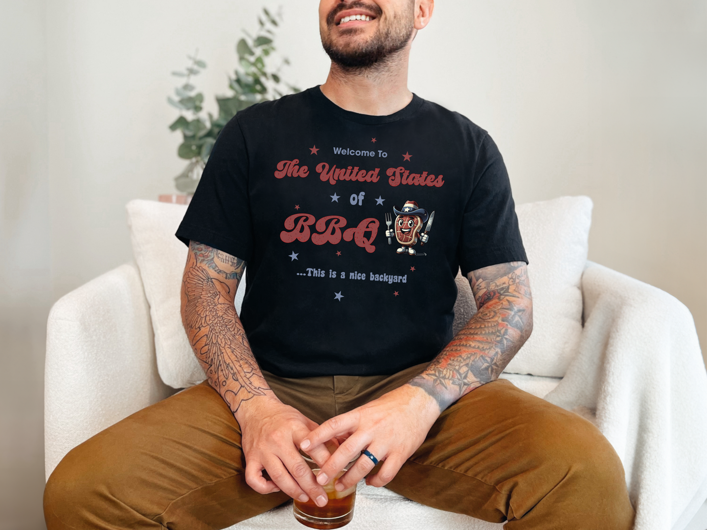 a man sitting on a couch with a drink in his hand