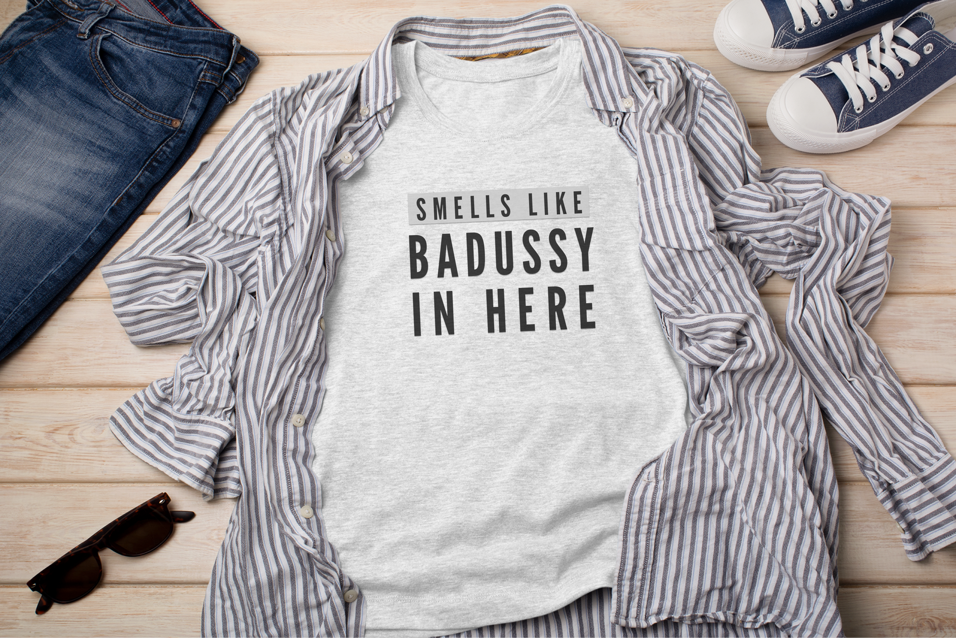 a shirt that says smells like badassy in here