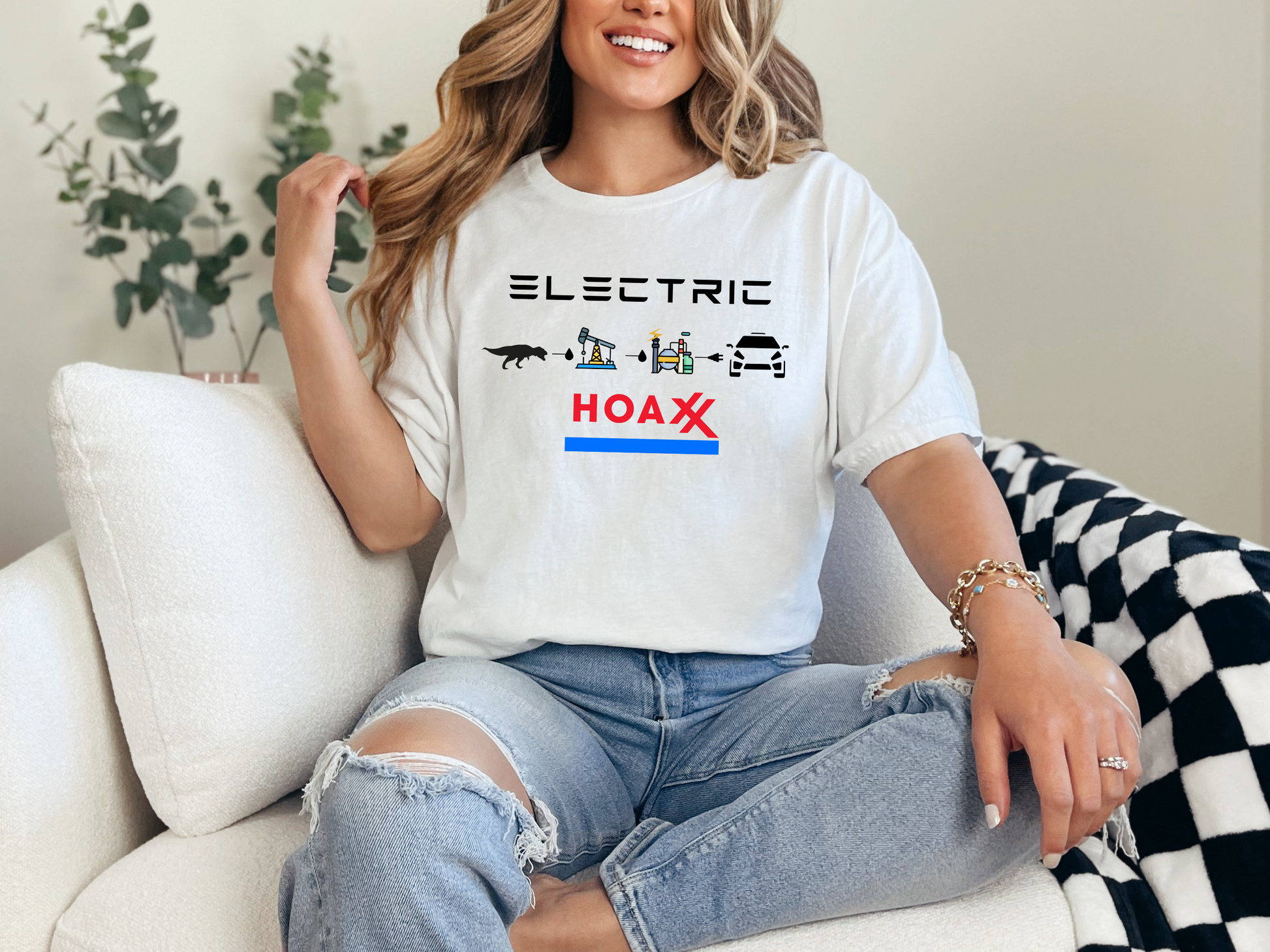 a woman sitting on a couch wearing a t - shirt that says electric hoax