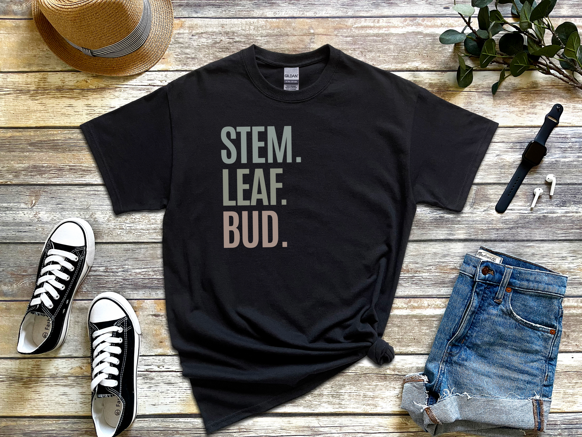 a t - shirt that says stem leaf bud next to a pair of jeans and