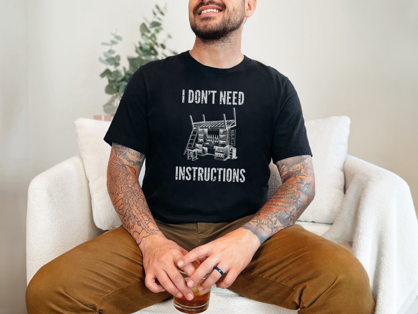 a man sitting on a couch with a drink in his hand