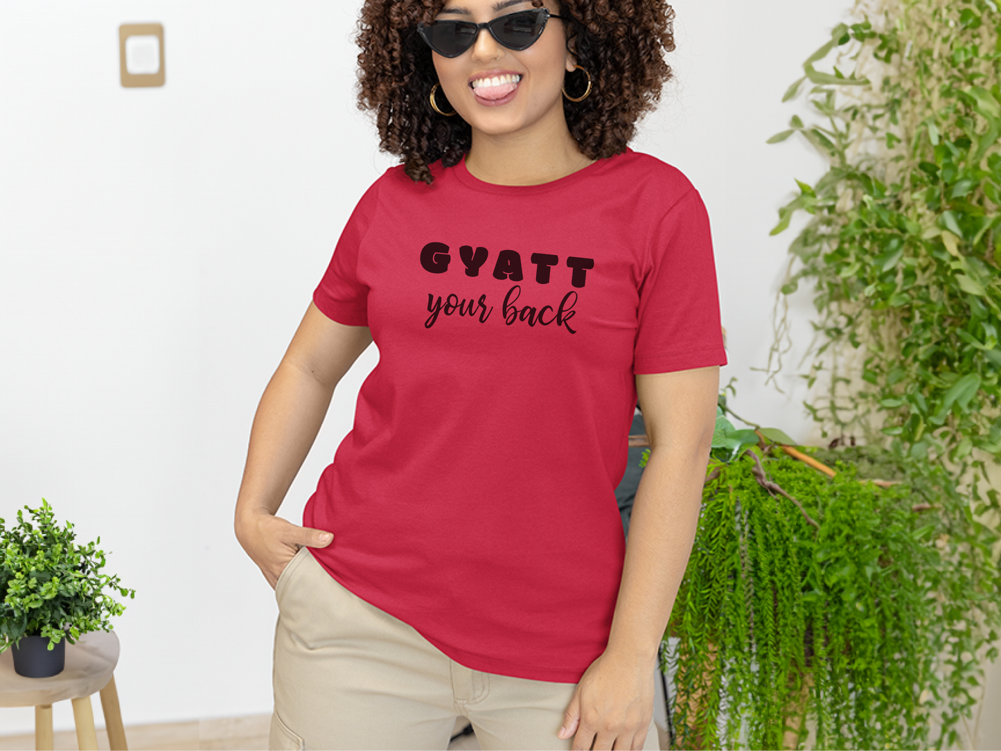 a woman wearing a red shirt that says gyatt your suck