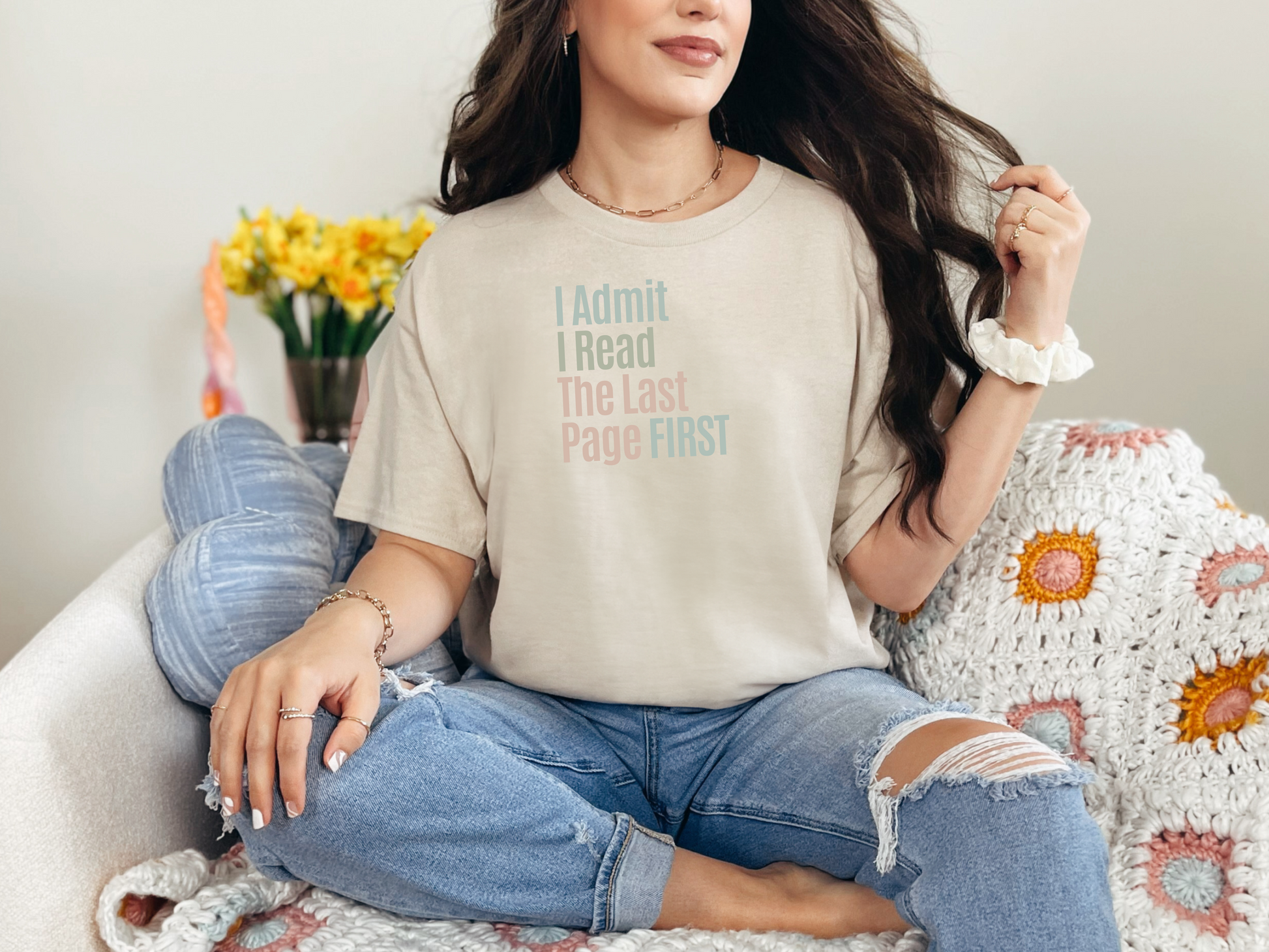 a woman sitting on a couch wearing a t - shirt that says i don '