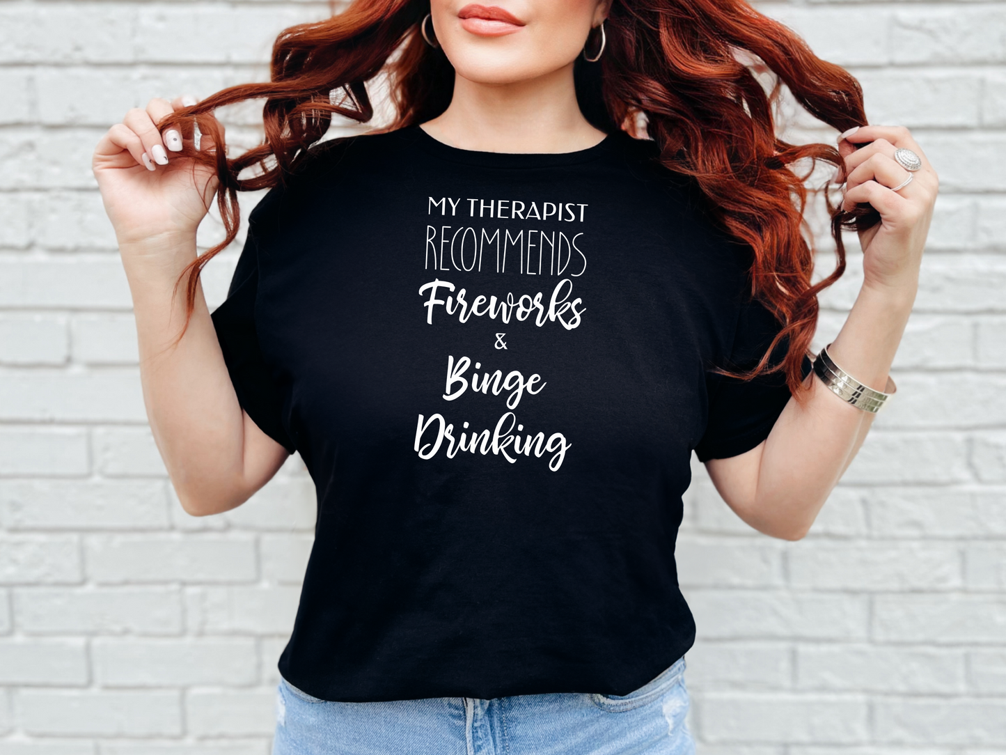 a woman wearing a black t - shirt with the words my therapiest