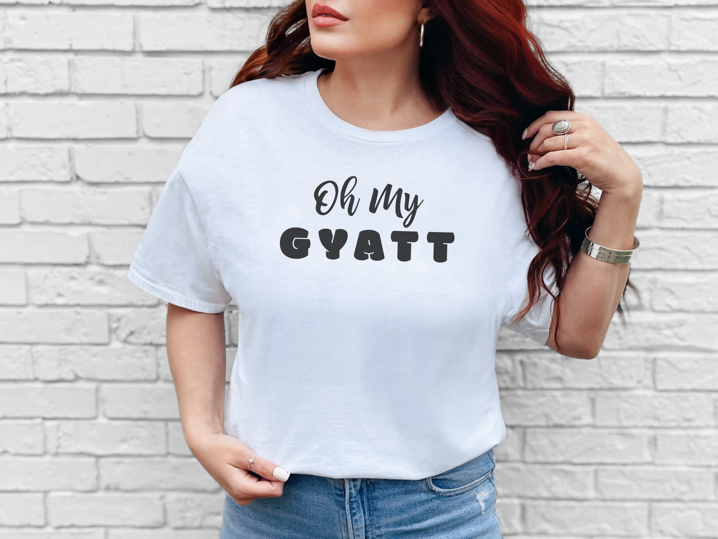 a woman wearing a white shirt that says oh my gyatt