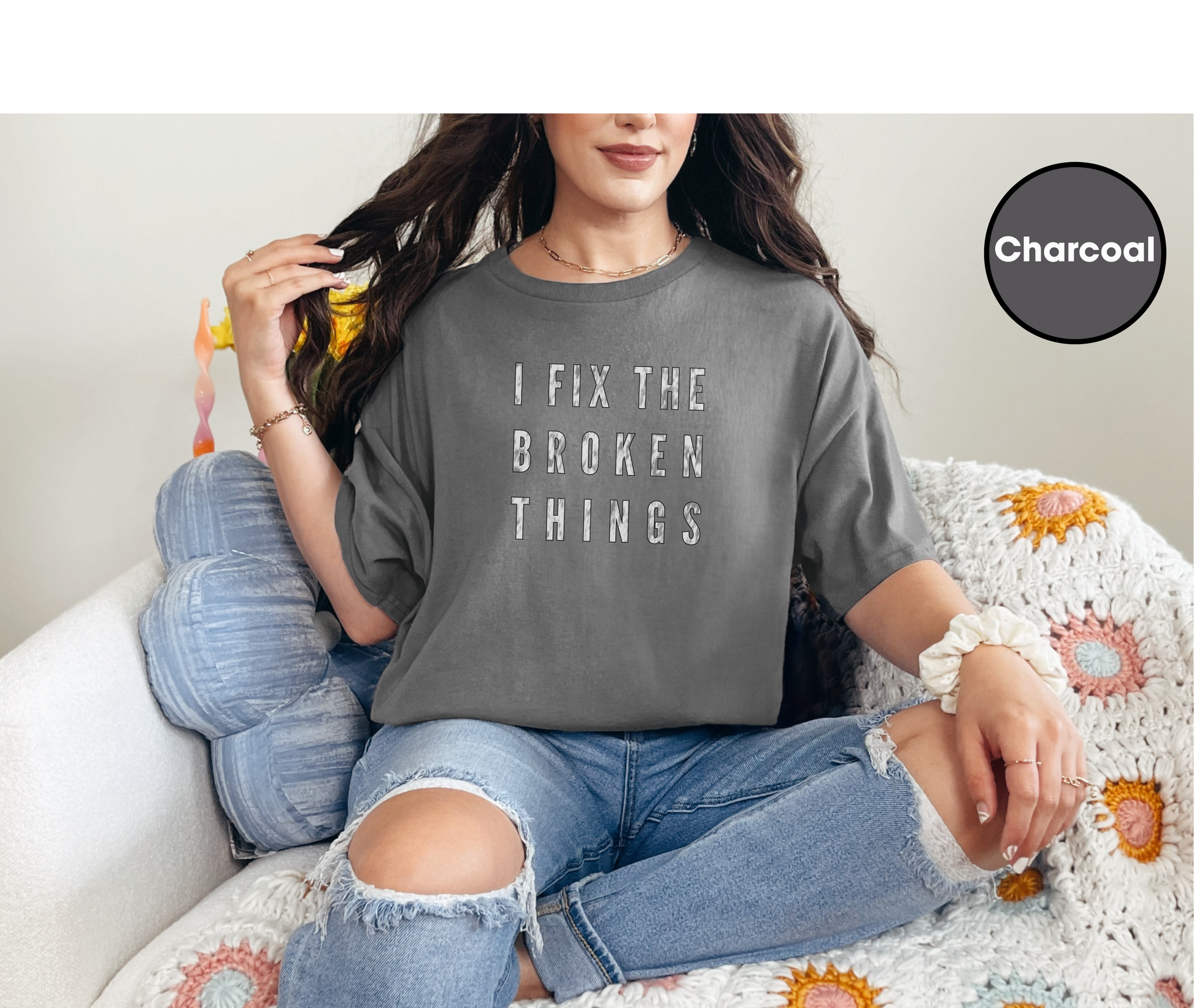 a woman sitting on a couch wearing a t - shirt that says i fix the