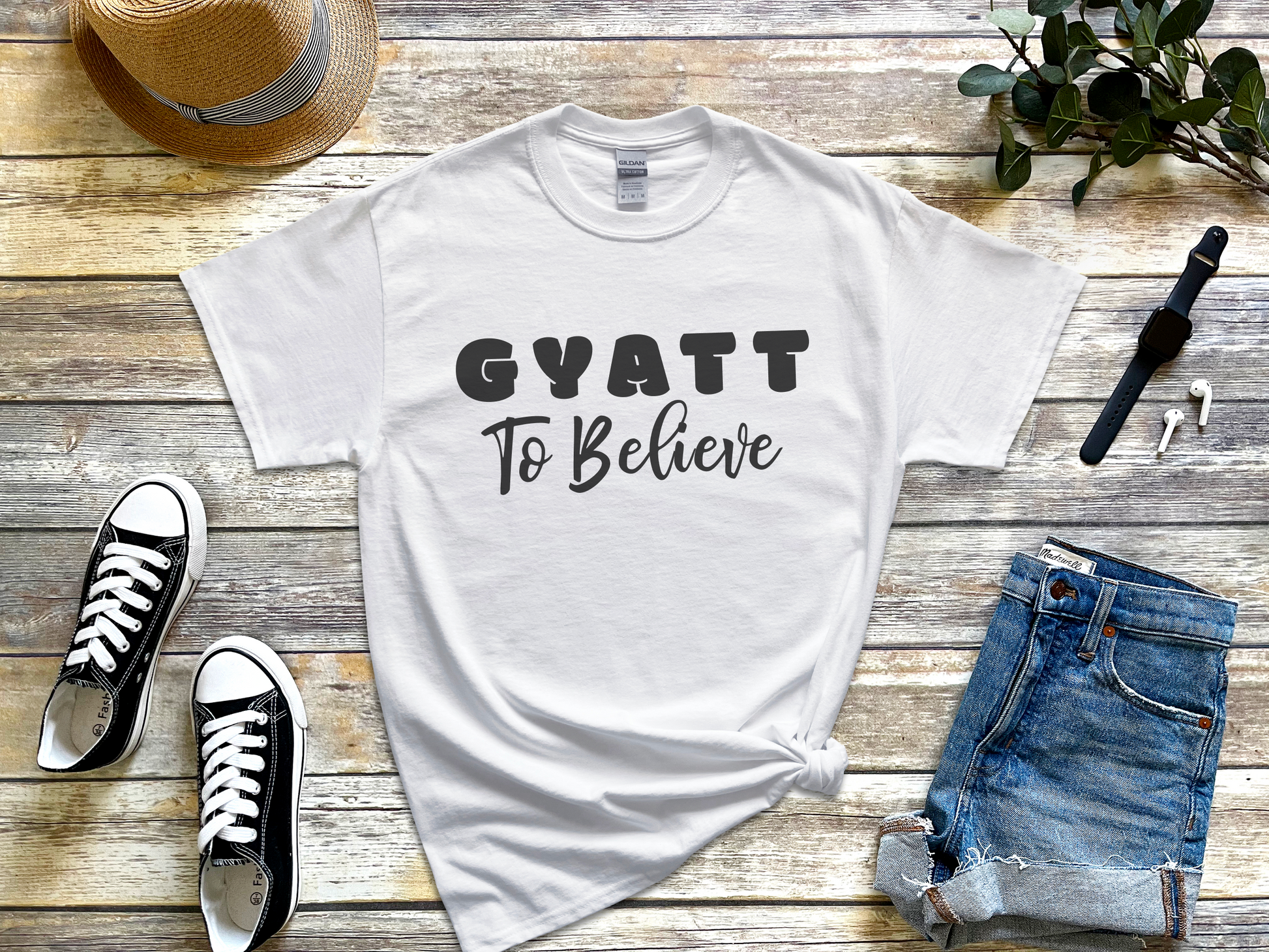 a t - shirt that says gyatt to believe next to a pair of