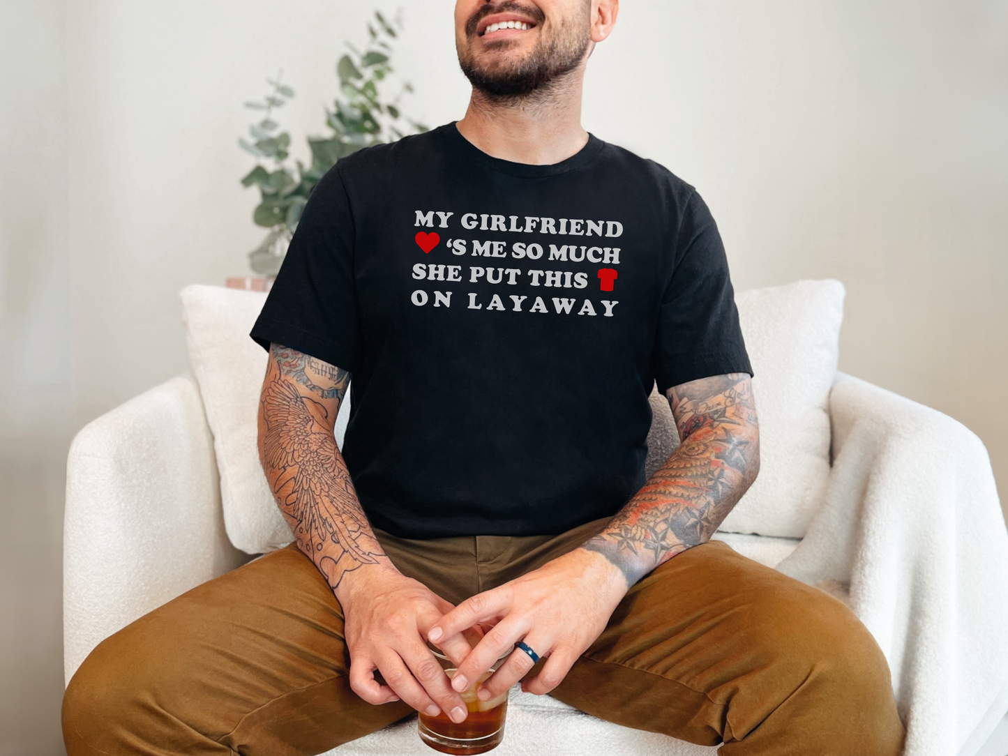 a man sitting on a couch with a drink in his hand