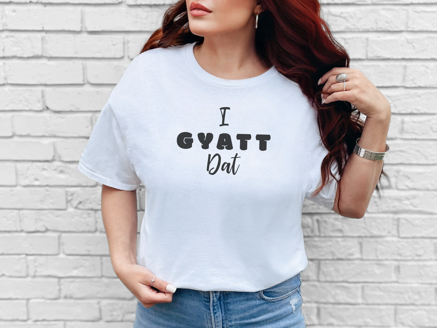 a woman wearing a white t - shirt that says i gyatt out