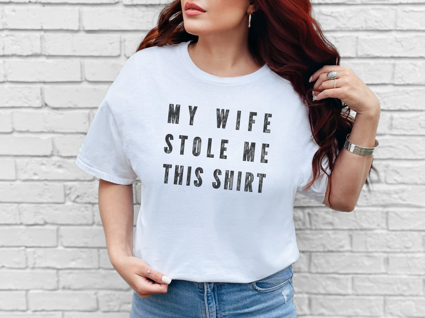 a woman wearing a white t - shirt that says, my wife stole me this