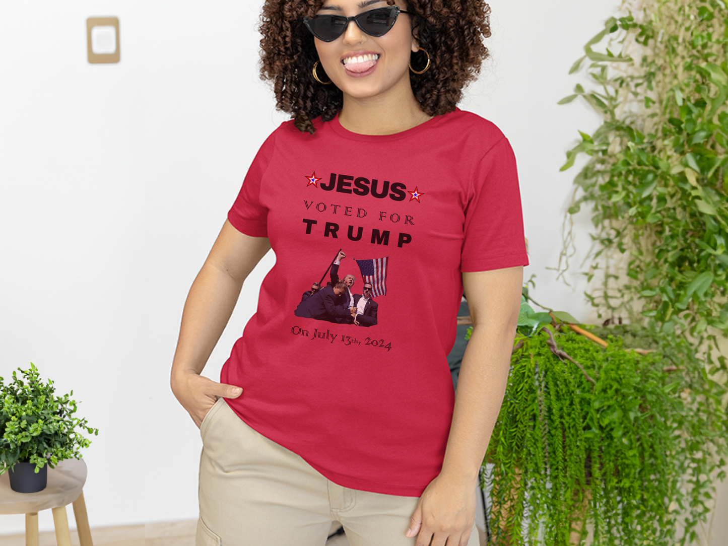 a woman wearing a red t - shirt with a picture of a man on it