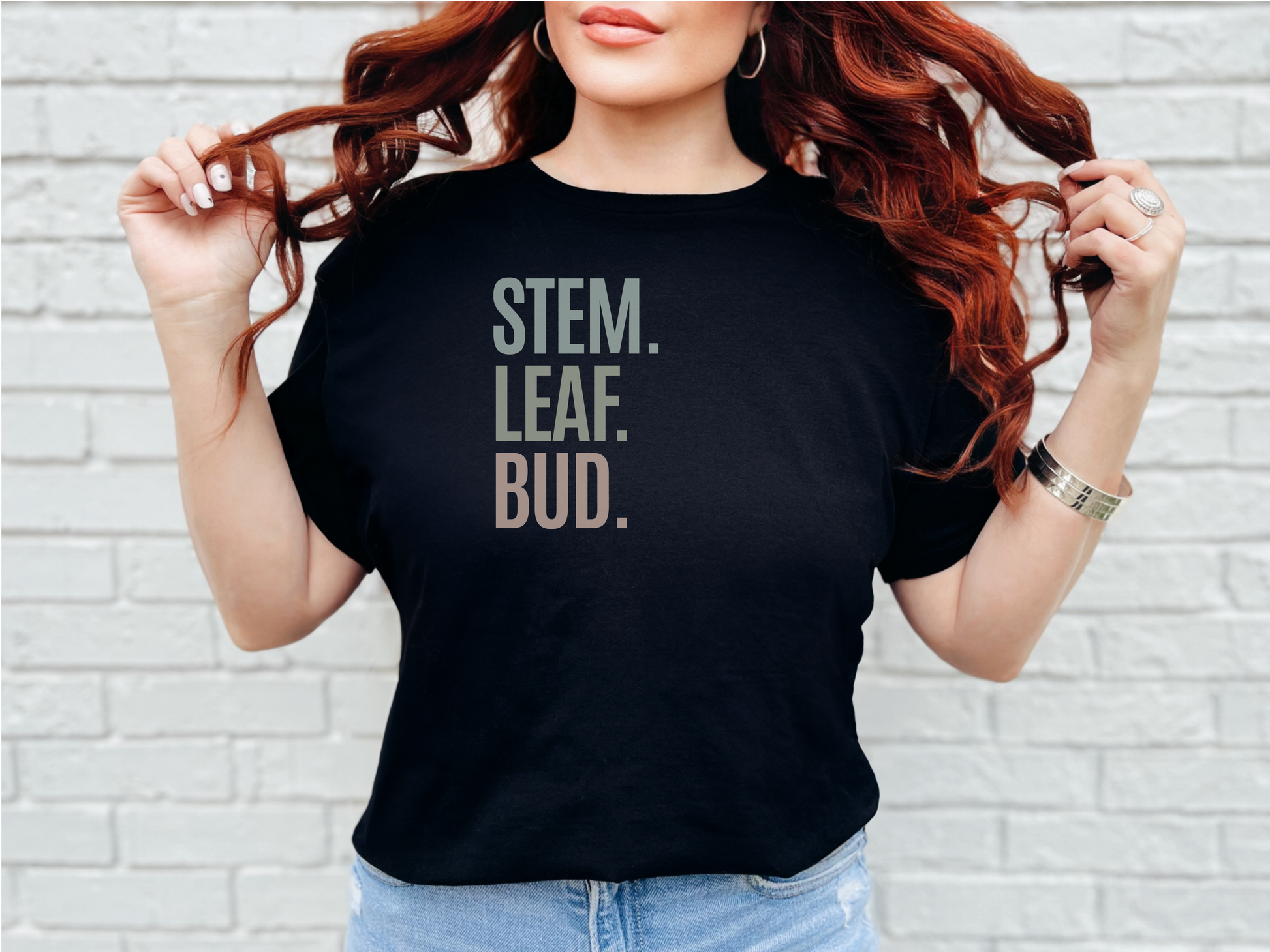 a woman with red hair wearing a stem leaf bud t - shirt