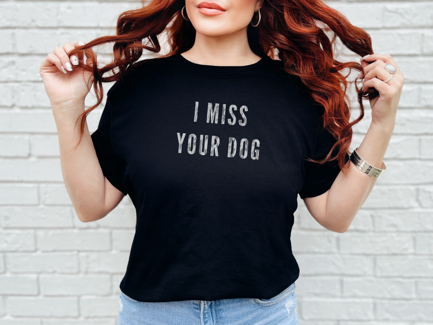 a woman wearing a black t - shirt that says i miss your dog