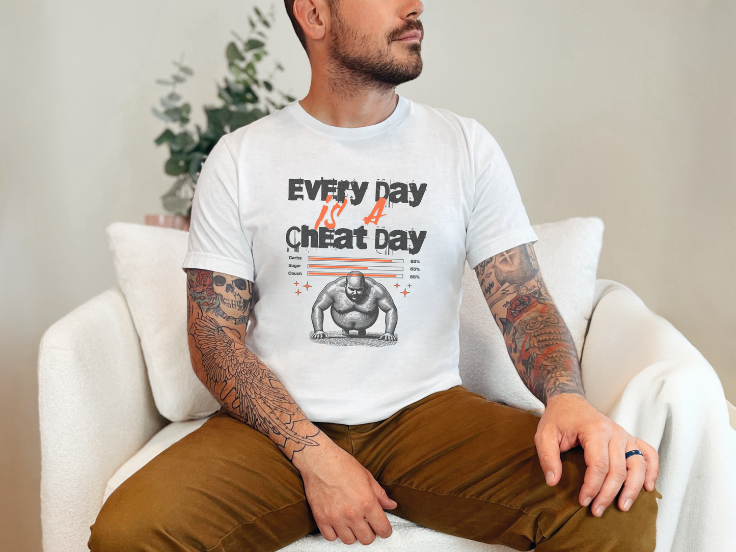 a man with a tattooed arm sitting on a white chair