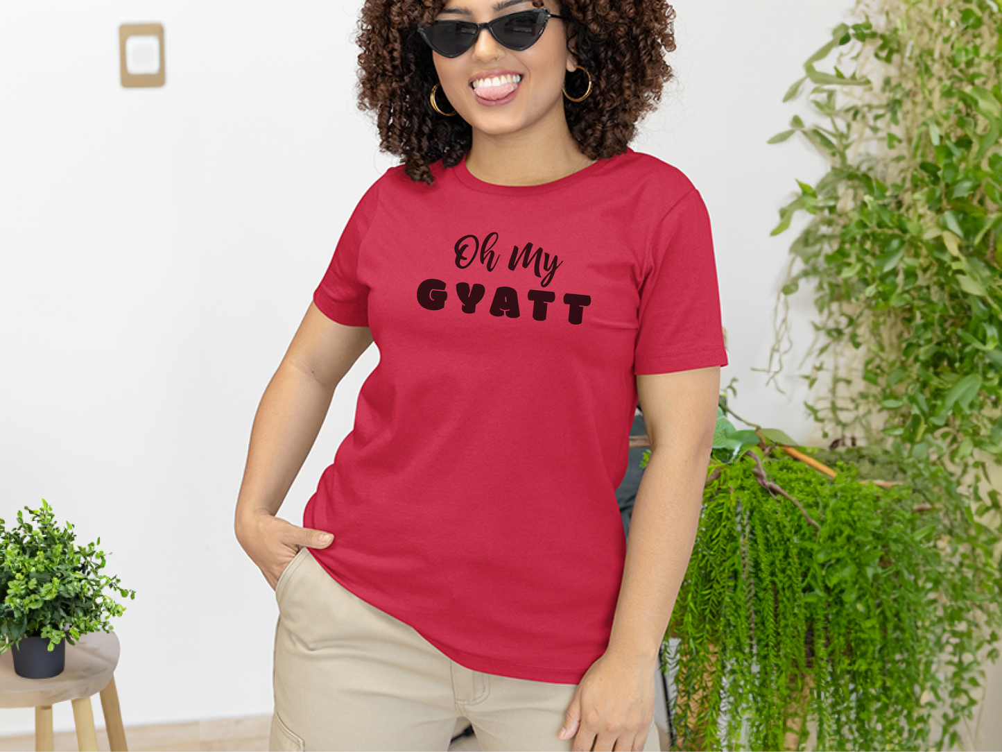 a woman wearing a red shirt that says oh my gyatt