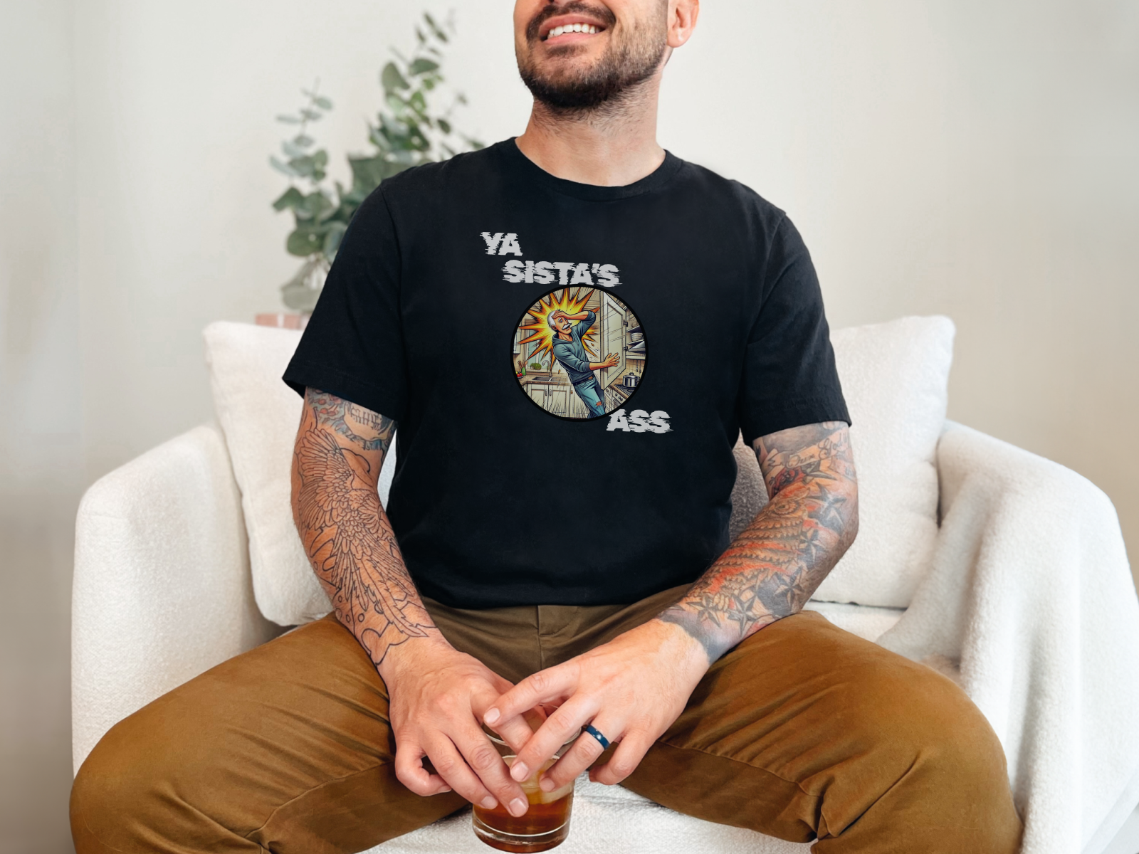 a man sitting on a couch with a drink in his hand