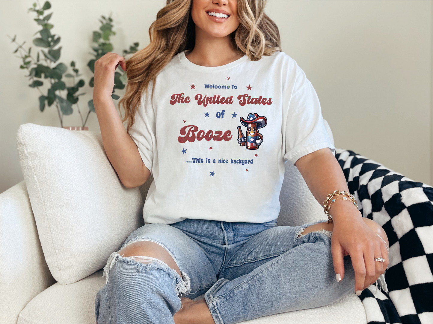 a woman sitting on a couch wearing a t - shirt that says the united states