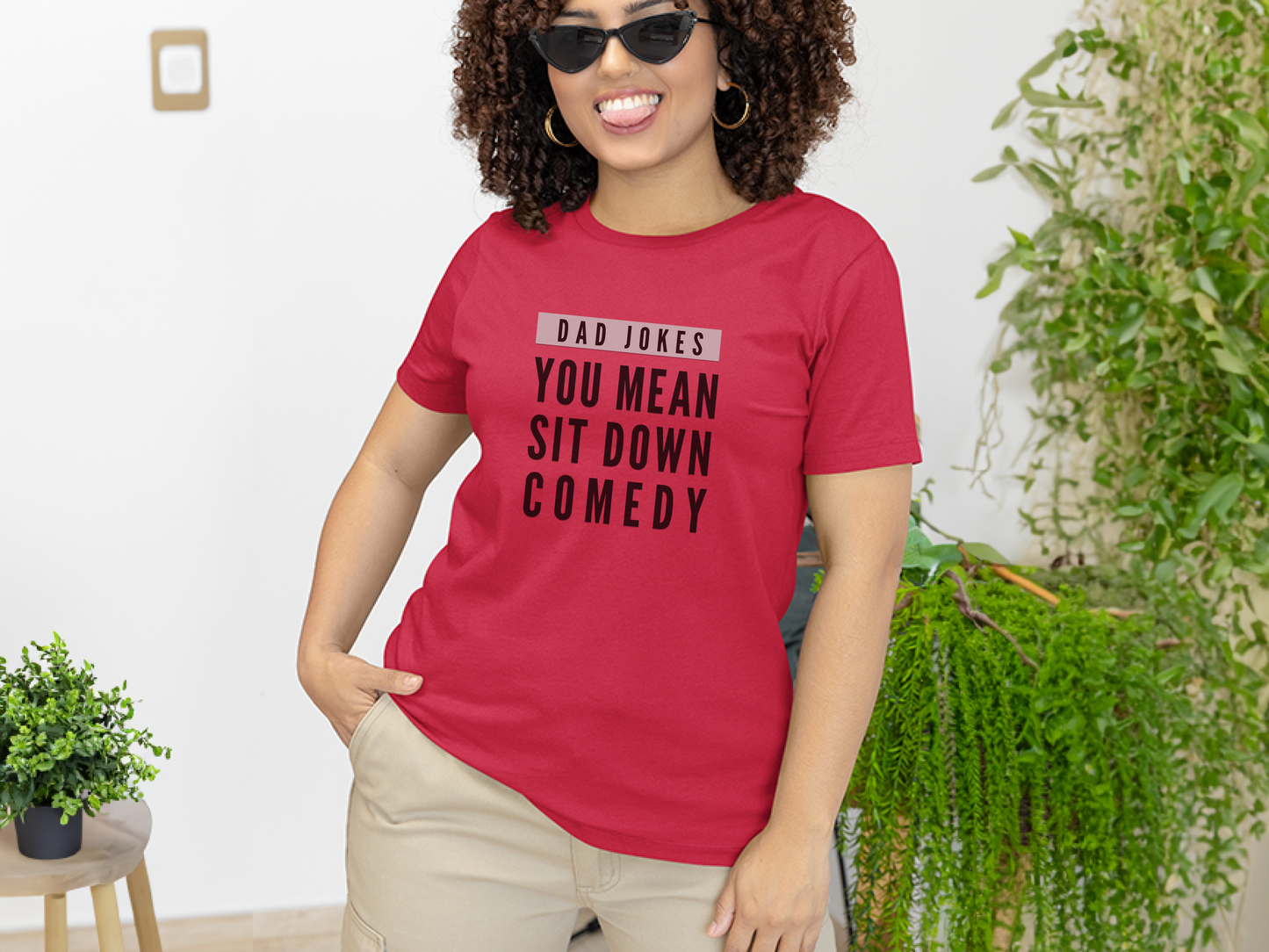 a woman wearing a red t - shirt that says, you mean sit down comedy