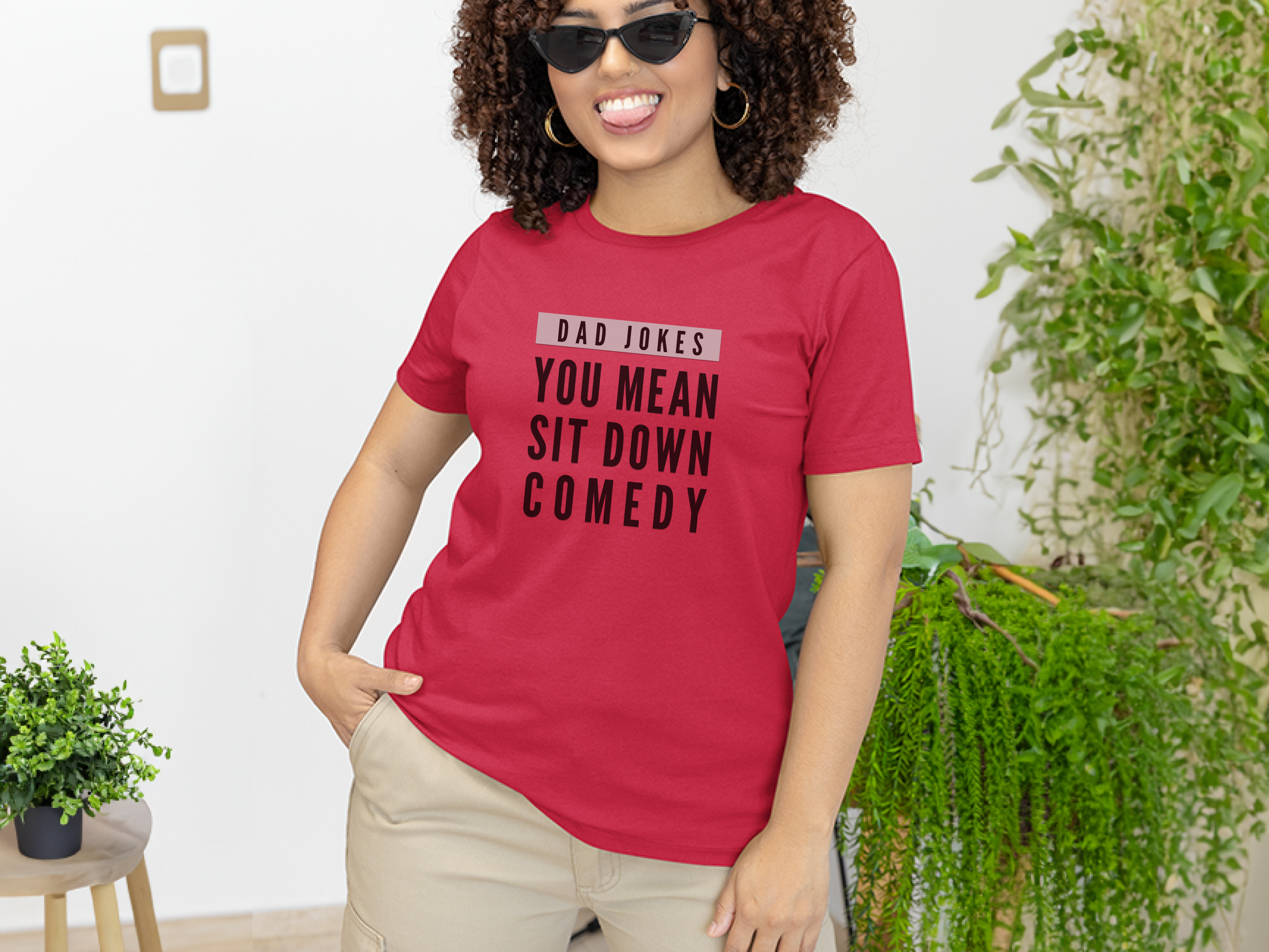 a woman wearing a red t - shirt that says, you mean sit down comedy