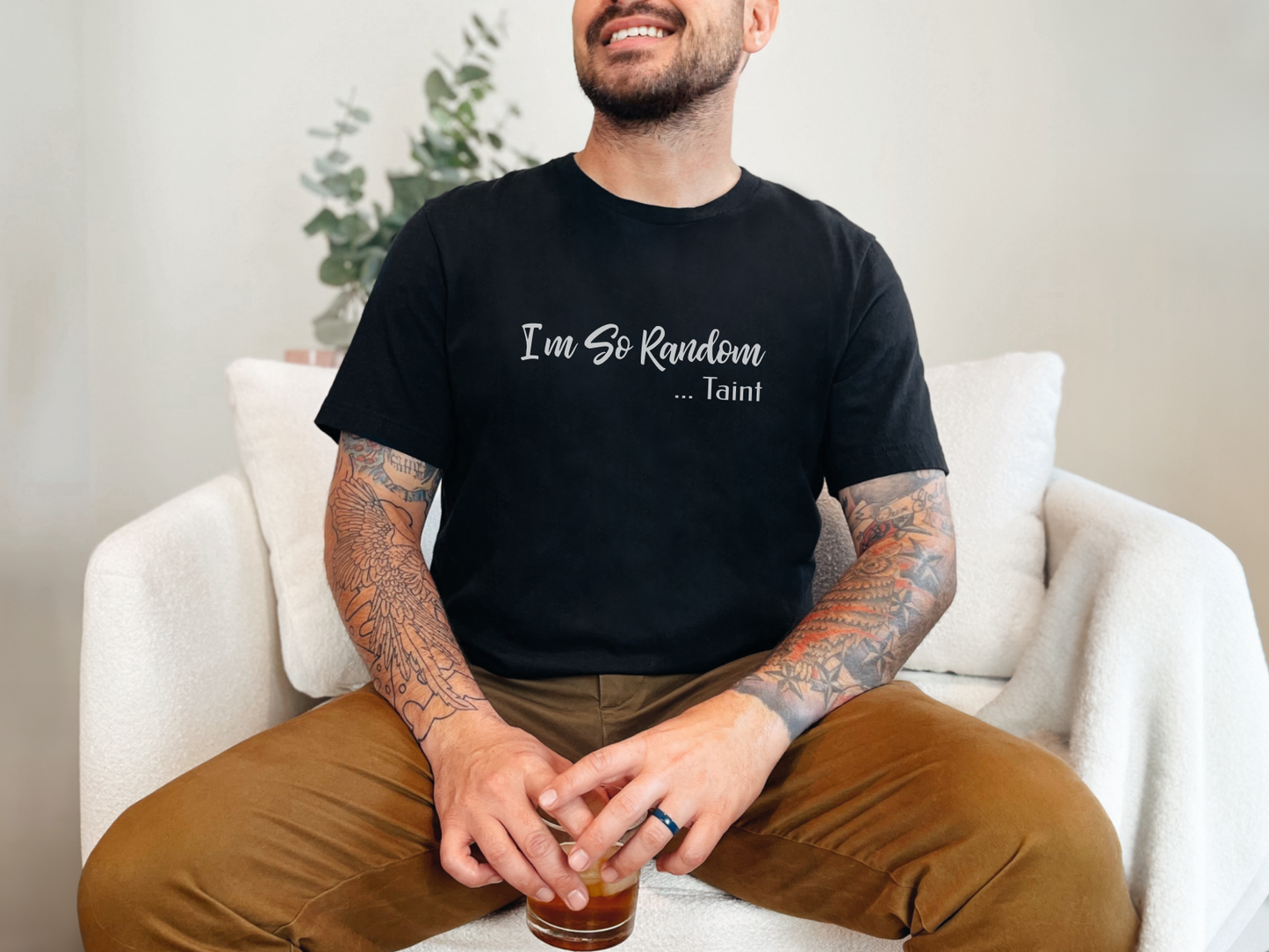 a man sitting on a couch with a drink in his hand