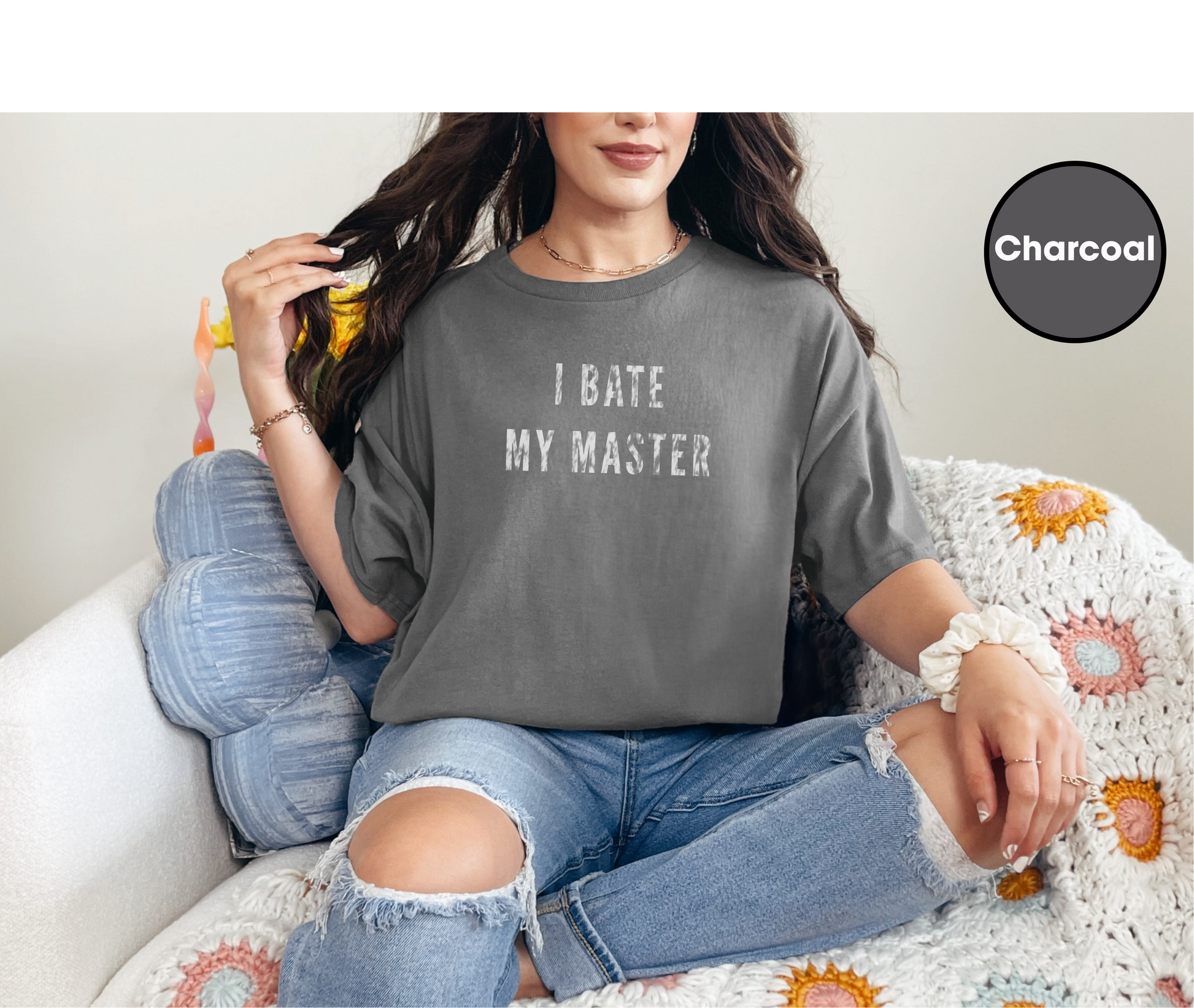 a woman sitting on a couch wearing a t - shirt that says i hate my