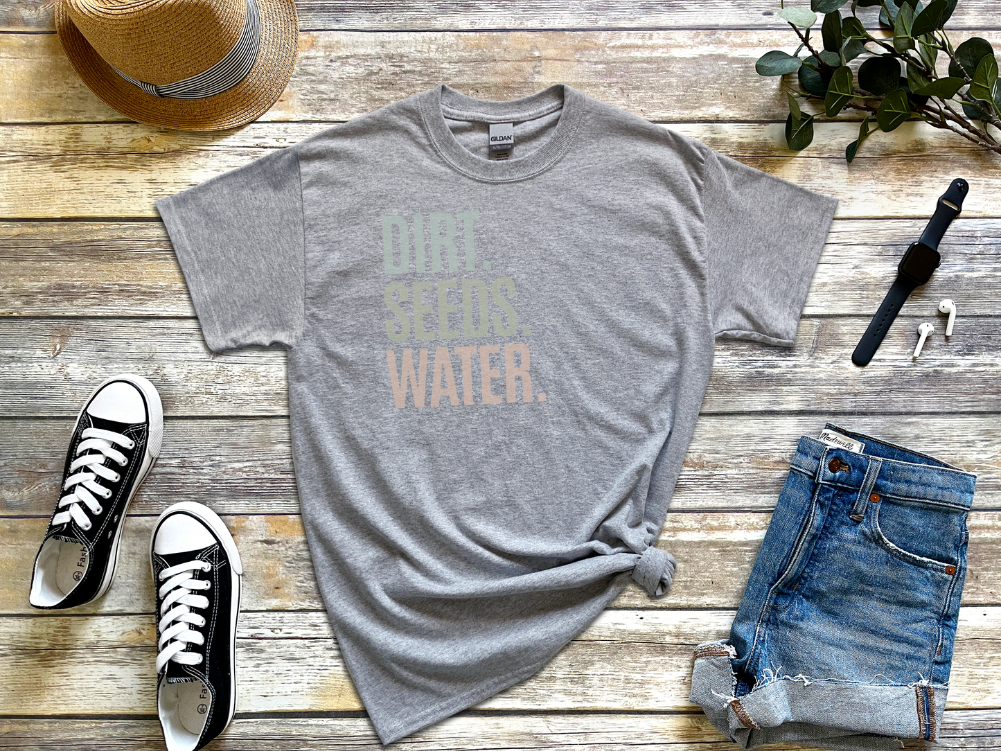 a t - shirt with the words water on it next to a pair of jeans