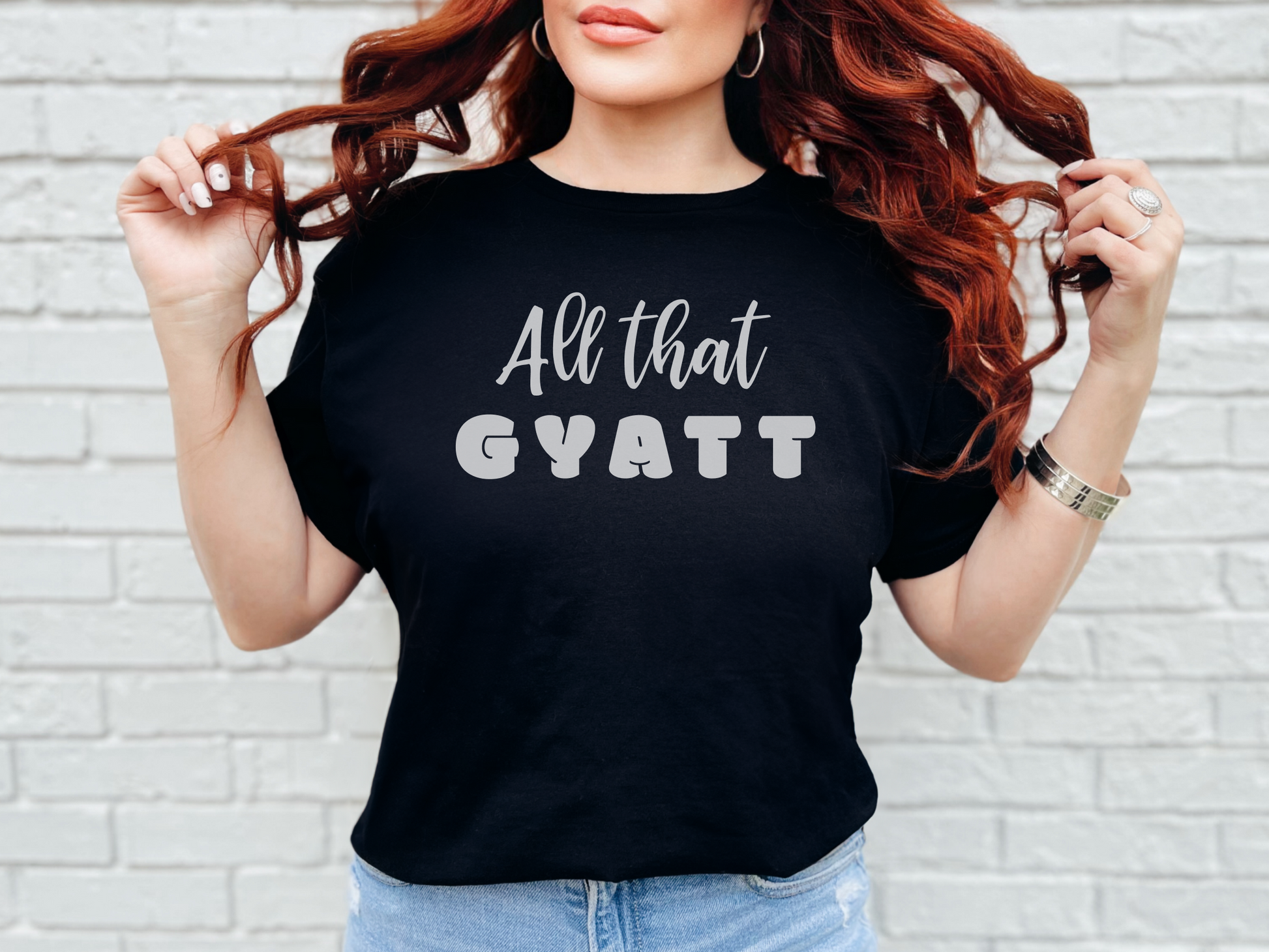 a woman wearing a black shirt that says, all that gyatt