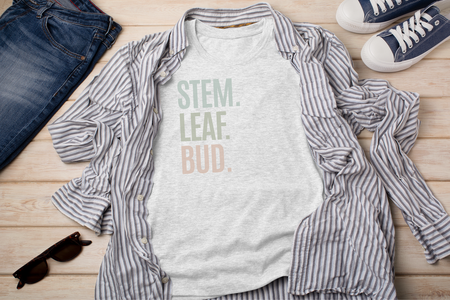 a t - shirt that says stem leaf bud next to a pair of jeans