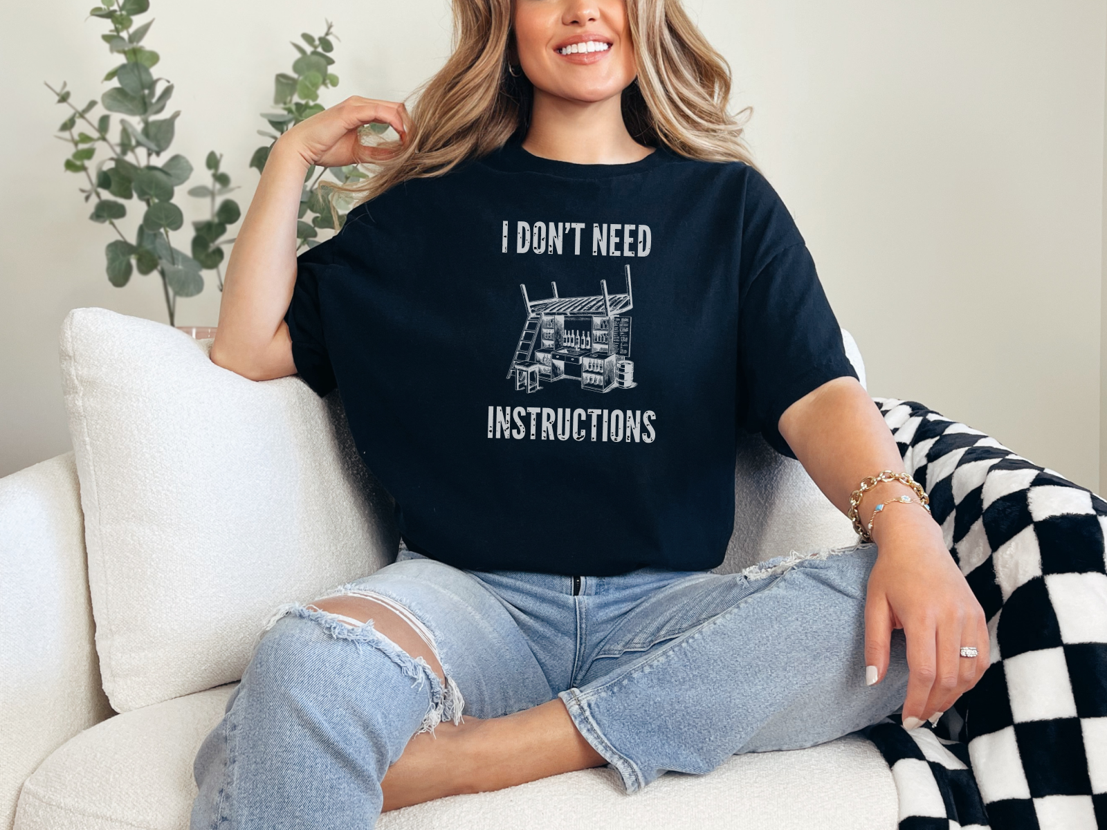 a woman sitting on a couch wearing a t - shirt that says i don '