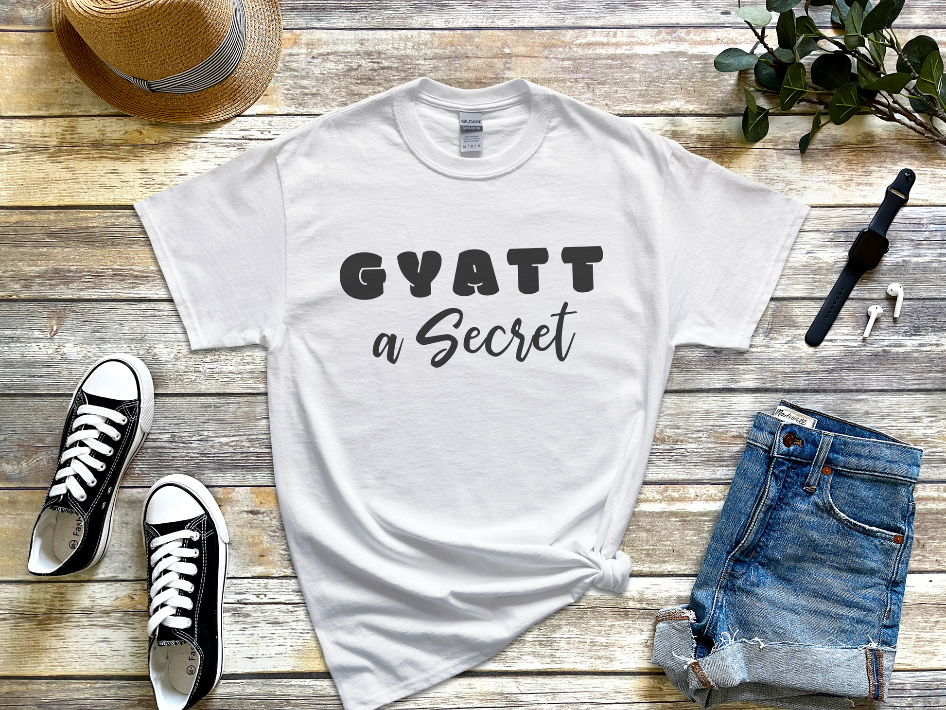 a t - shirt that says gyatt a secret next to a pair of