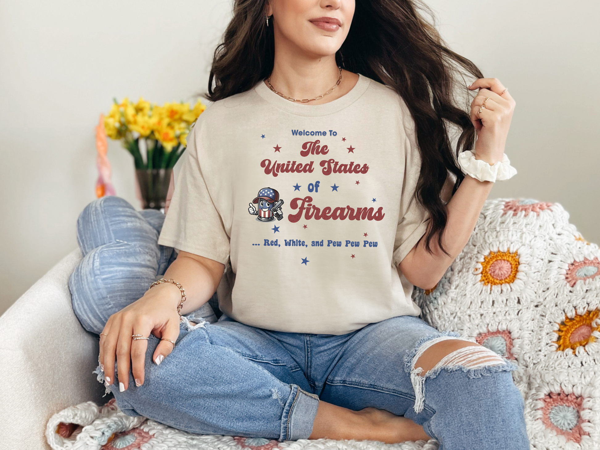 a woman sitting on a couch wearing a t - shirt that says the united states