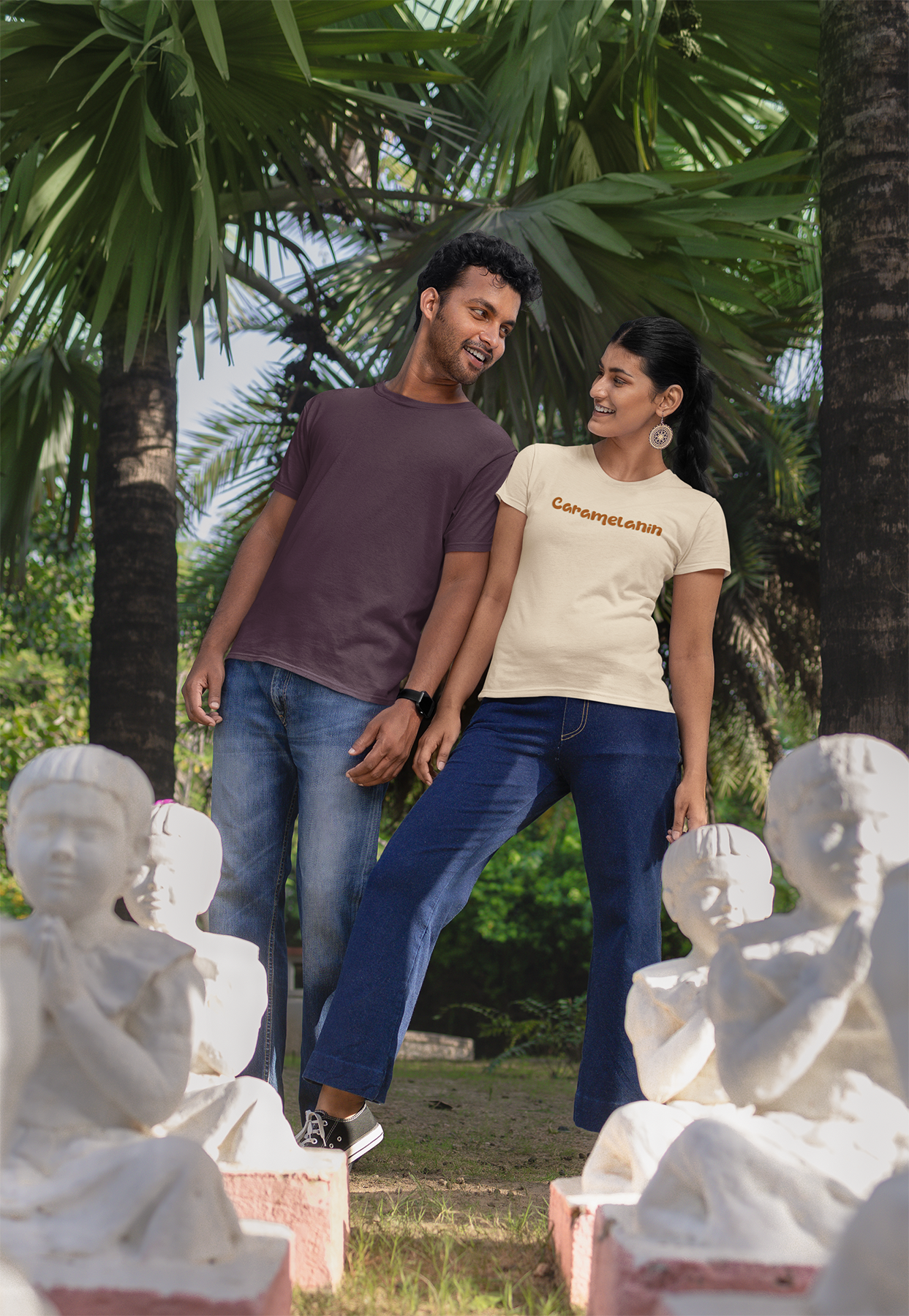 a man and a woman standing next to a statue