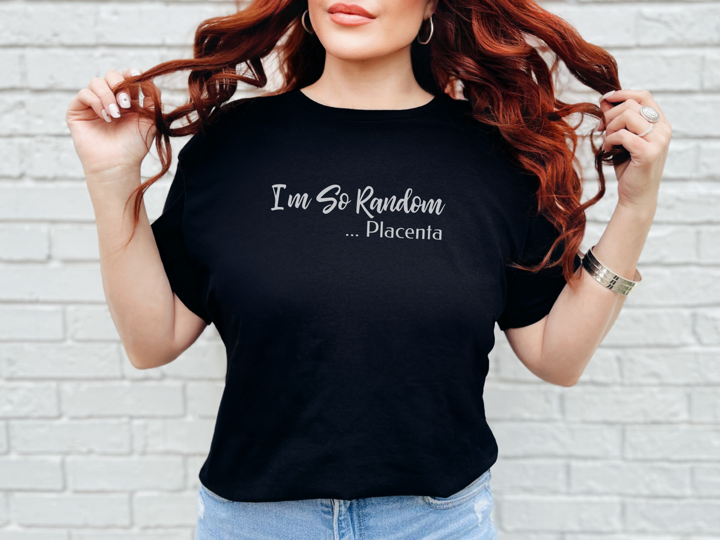 a woman wearing a black t - shirt that says i'm so random place