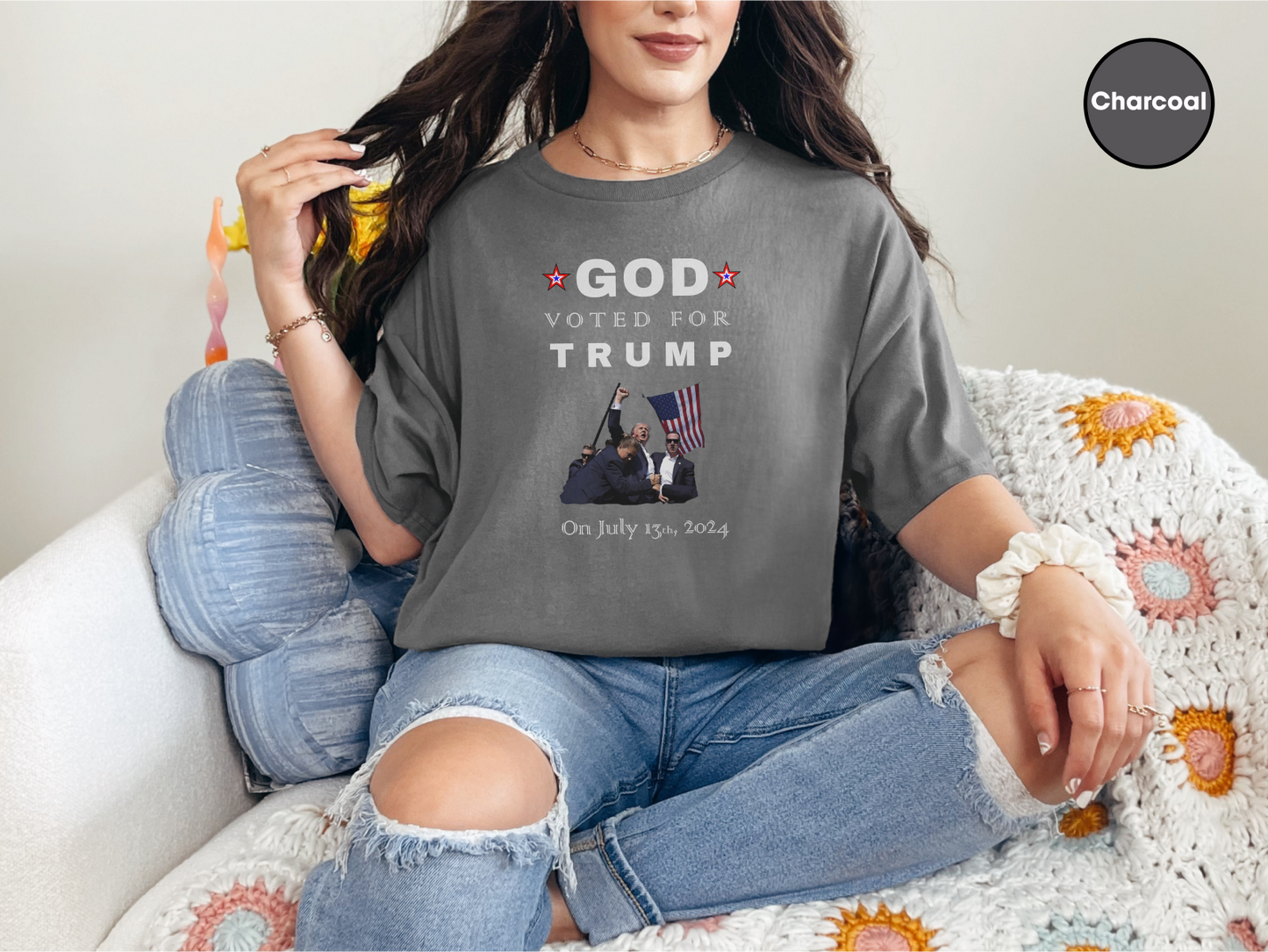 a woman sitting on top of a couch wearing a t - shirt