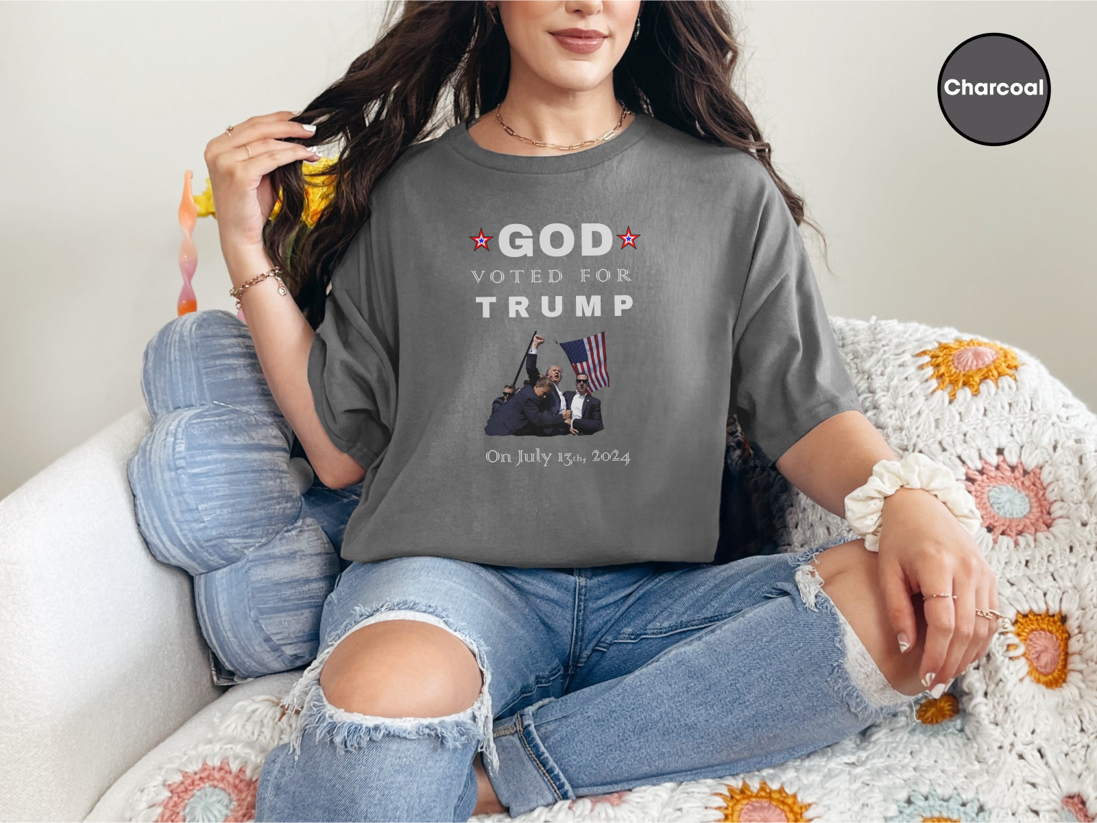 a woman sitting on top of a couch wearing a t - shirt