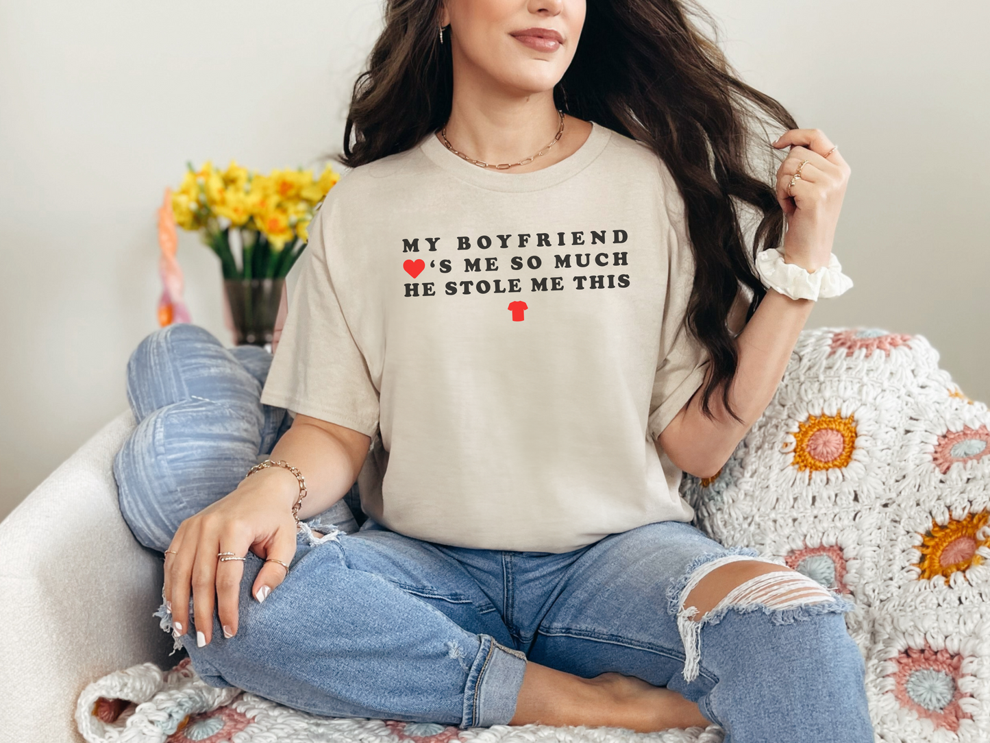 a woman sitting on a couch wearing a t - shirt that says, my boyfriend