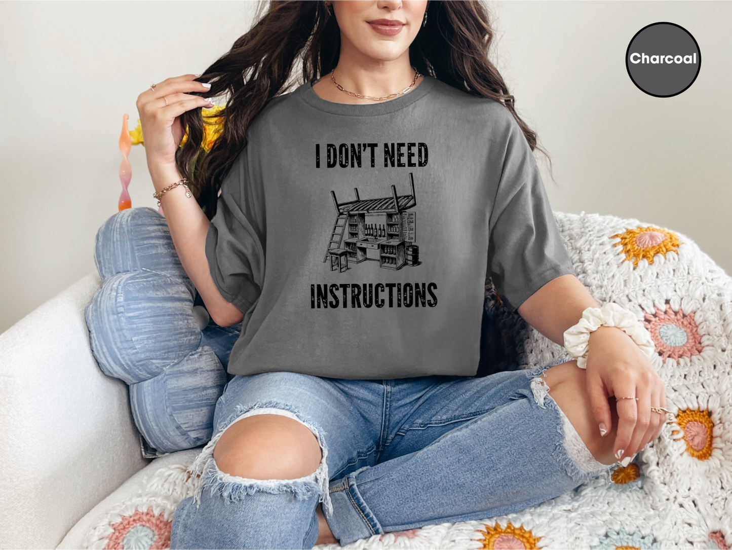 a woman sitting on a couch wearing a t - shirt that says i don '