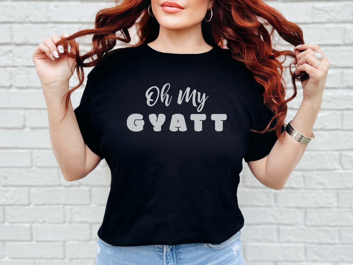 a woman wearing a black shirt that says oh my gyatt