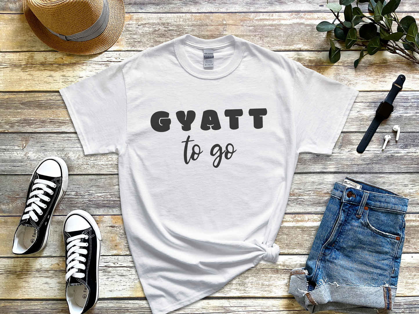 a t - shirt that says gyatt to go next to a pair of